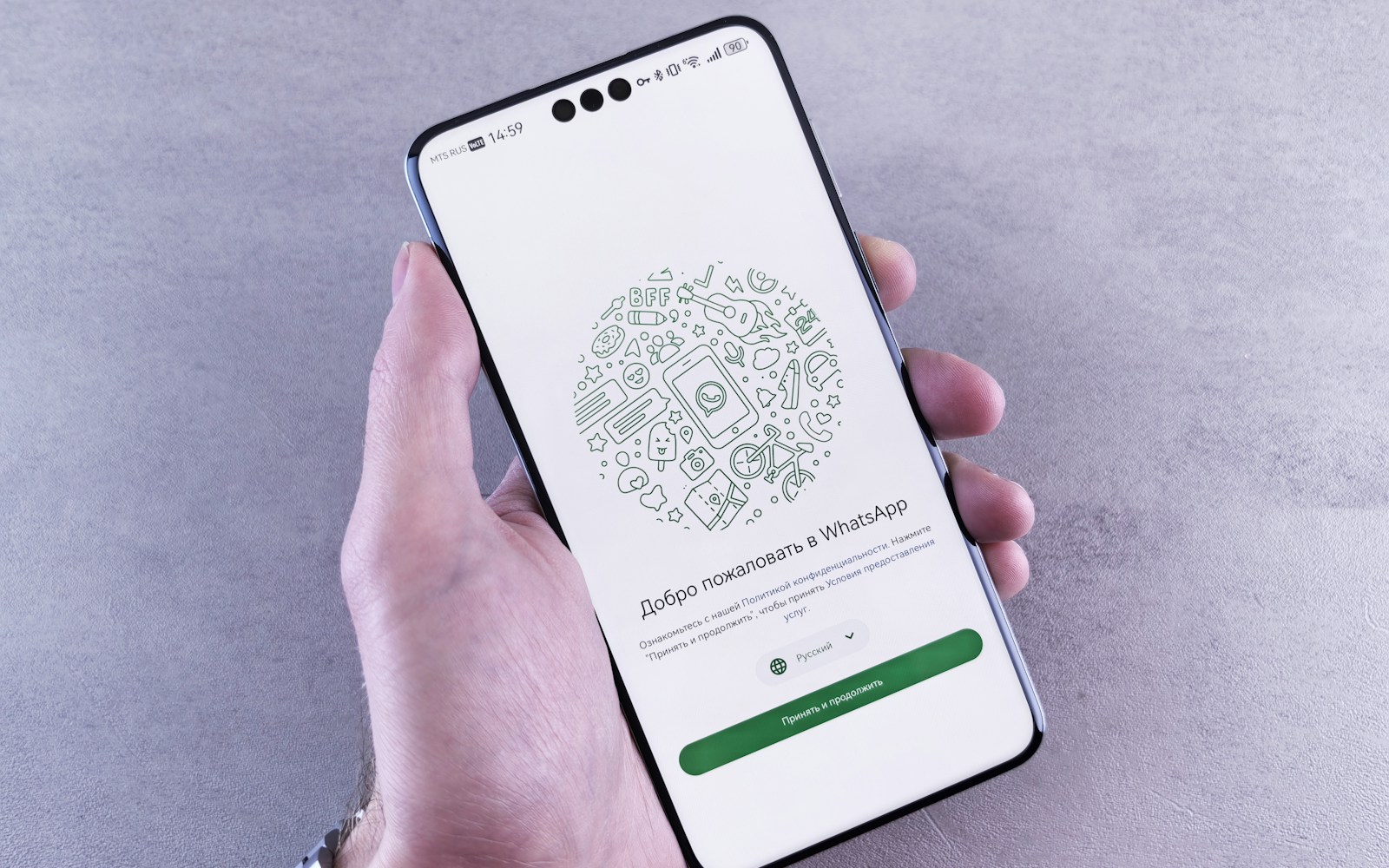 Hand holding a phone with WhatsApp open